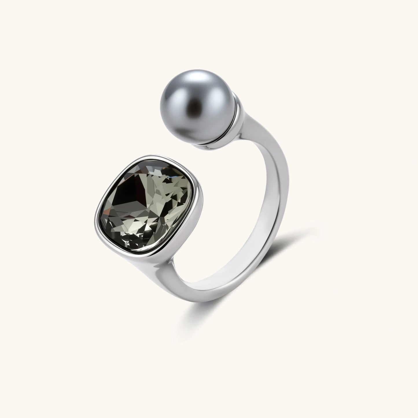 Modern adjustable ring with smoky zircon stone and metallic sphere in platinum-plated copper finish on neutral background.