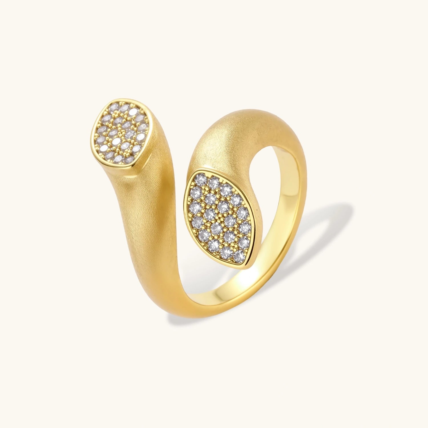 Open-band gold-plated ring with two oval pavé zirconia sections positioned at opposite ends, adjustable design
