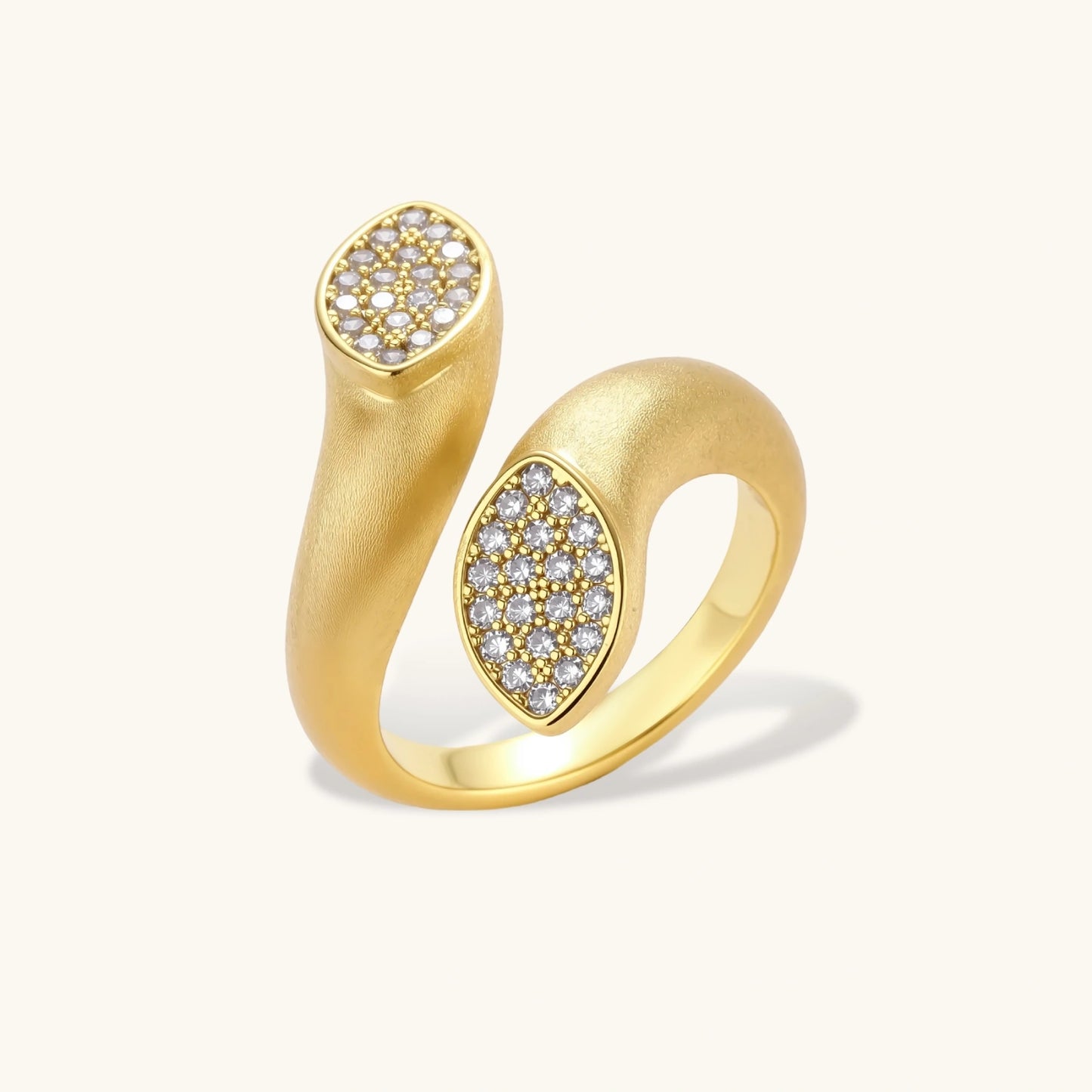 Open-band gold-plated ring with two oval pavé zirconia sections positioned at opposite ends, adjustable design