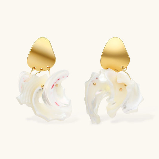 Gold-plated copper earrings with organic pebble studs and natural shell drops on cream background.