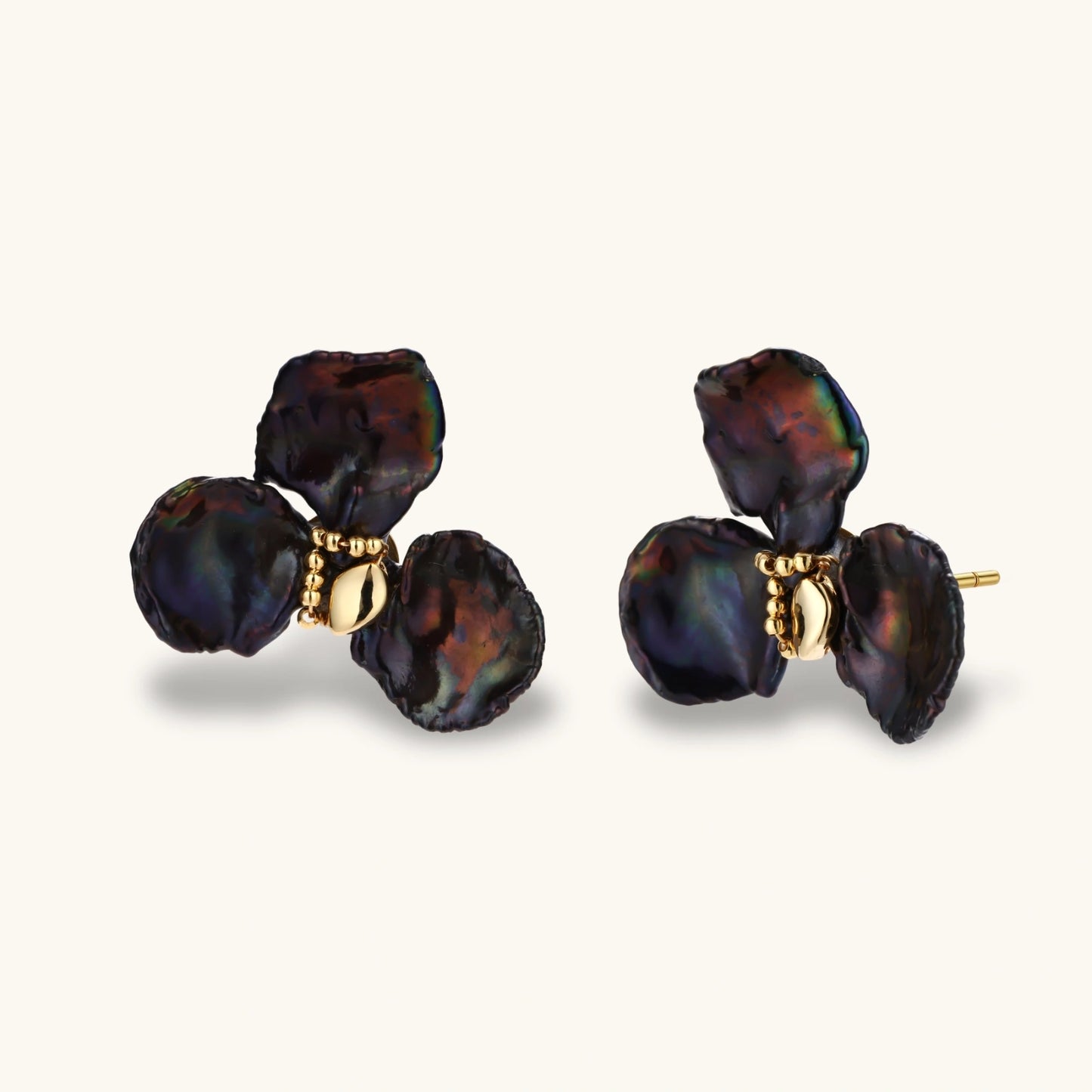 Dark baroque pearl cluster earrings with gold centres, showing peacock and plum iridescence