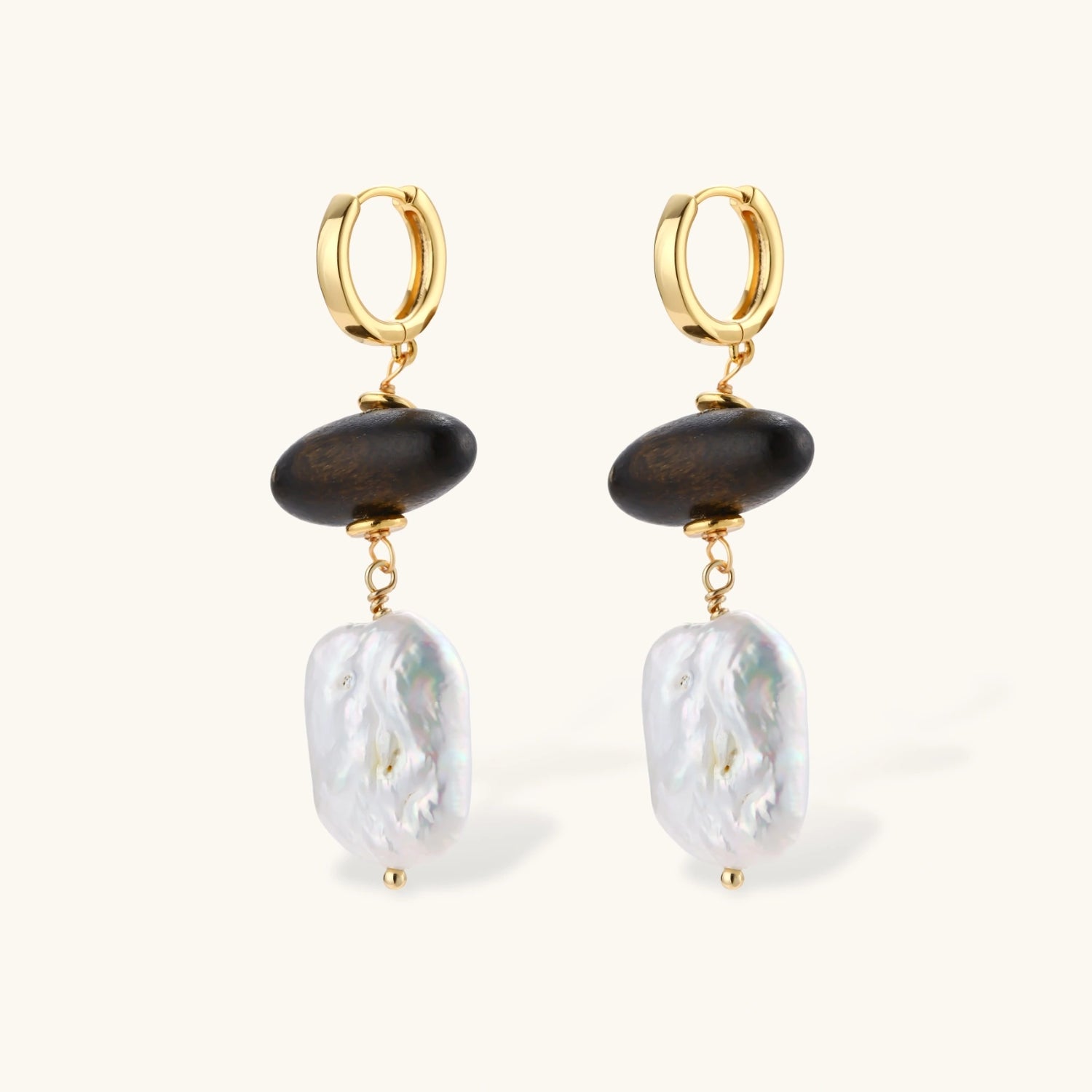 Gold hoop earrings with dark wood beads and baroque freshwater pearls, shown from multiple angles on cream background.